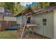 Backyard playhouse featuring a small deck, ladder, and a view of the garden at 222 Winonna Dr, Decatur, GA 30030