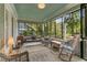 Relaxing screened porch with wicker furniture, a swing, and views of the surrounding greenery at 222 Winonna Dr, Decatur, GA 30030