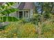 Exterior of home featuring a flower garden filled with black-eyed susans and lush foliage at 222 Winonna Dr, Decatur, GA 30030