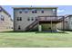 Exterior backyard features a large lawn, a wood deck with stairs to the yard, and tidy landscaping at 4395 Wildbrooke Pkwy, Cumming, GA 30041