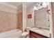 Bathroom featuring a granite countertop, a mirror, modern lighting, and a shower over tub with tiled walls at 4395 Wildbrooke Pkwy, Cumming, GA 30041