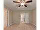 Spacious bedroom featuring carpet flooring, two windows, and two doors at 4395 Wildbrooke Pkwy, Cumming, GA 30041
