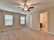Bedroom with ceiling fan, carpet flooring, and natural light from the two windows at 4395 Wildbrooke Pkwy, Cumming, GA 30041