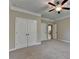 Bedroom featuring neutral carpet, closet, and open doorway to other rooms at 4395 Wildbrooke Pkwy, Cumming, GA 30041