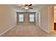 Bedroom with ceiling fan, carpet flooring, and natural light from the two windows at 4395 Wildbrooke Pkwy, Cumming, GA 30041