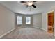 Bedroom features carpeted floors, windows and a bathroom at 4395 Wildbrooke Pkwy, Cumming, GA 30041