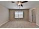 Bedroom with ceiling fan, carpet flooring, and natural light from the window at 4395 Wildbrooke Pkwy, Cumming, GA 30041