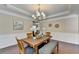 Elegant dining room with a decorative chandelier, and natural light at 4395 Wildbrooke Pkwy, Cumming, GA 30041