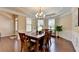 Bright dining room showcasing wood floors, natural light, and stylish decor at 4395 Wildbrooke Pkwy, Cumming, GA 30041