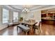 Charming dining room with wood floors, wainscoting, and a modern chandelier at 4395 Wildbrooke Pkwy, Cumming, GA 30041