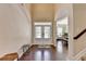Bright foyer with hardwood floors and an open view to the living spaces at 4395 Wildbrooke Pkwy, Cumming, GA 30041