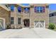 Attractive brick home featuring a two-car garage and neat landscaping at 4395 Wildbrooke Pkwy, Cumming, GA 30041