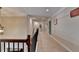 Hallway featuring carpet, neutral walls, and elegant trim for a refined aesthetic at 4395 Wildbrooke Pkwy, Cumming, GA 30041
