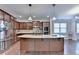 Spacious kitchen with stainless appliances, granite counters, and a center island at 4395 Wildbrooke Pkwy, Cumming, GA 30041