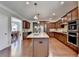 Open kitchen layout featuring a center island, granite countertops, and hardwood flooring at 4395 Wildbrooke Pkwy, Cumming, GA 30041