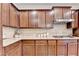 Kitchen features granite countertops, tile backsplash and wooden cabinets at 4395 Wildbrooke Pkwy, Cumming, GA 30041