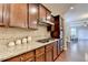 Modern kitchen with tile backsplash, gas range, wooden cabinets and stainless appliances at 4395 Wildbrooke Pkwy, Cumming, GA 30041