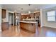 Well-equipped kitchen with stainless steel appliances, a central island, and elegant cabinetry and hardwood floors at 4395 Wildbrooke Pkwy, Cumming, GA 30041