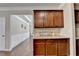 Kitchen cabinets with granite countertops and a backsplash with a 'Let's Eat' sign at 4395 Wildbrooke Pkwy, Cumming, GA 30041