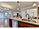Bright kitchen showcasing granite countertops, stainless steel appliances, and hardwood floors with an open concept at 4395 Wildbrooke Pkwy, Cumming, GA 30041