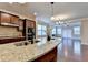 Spacious kitchen with granite countertops, hardwood floors, stainless steel appliances, and modern lighting at 4395 Wildbrooke Pkwy, Cumming, GA 30041