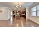Bright living room showcasing hardwood floors and a view into an open-concept kitchen at 4395 Wildbrooke Pkwy, Cumming, GA 30041