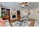 Comfortable living room featuring a stone fireplace, custom built-ins, and plenty of natural light at 4395 Wildbrooke Pkwy, Cumming, GA 30041