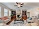 Comfortable living room featuring a stone fireplace, custom built-ins, and plenty of natural light at 4395 Wildbrooke Pkwy, Cumming, GA 30041