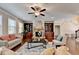 Comfortable living room featuring a stone fireplace, custom built-ins, and plenty of natural light at 4395 Wildbrooke Pkwy, Cumming, GA 30041