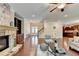 Spacious living room with a stone fireplace, hardwood floors, and seamless access to other areas of the home at 4395 Wildbrooke Pkwy, Cumming, GA 30041