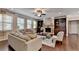 Bright living room with stone fireplace, hardwood floors, with multiple sofas for ample seating at 4395 Wildbrooke Pkwy, Cumming, GA 30041