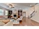 Comfortable living room with a ceiling fan, hardwood floors, a stone fireplace, and convenient built-in shelving at 4395 Wildbrooke Pkwy, Cumming, GA 30041