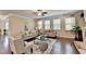 Bright living room with stone fireplace, hardwood floors, with multiple sofas for ample seating at 4395 Wildbrooke Pkwy, Cumming, GA 30041