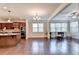 An open-concept living area featuring hardwood floors, large windows, and modern kitchen at 4395 Wildbrooke Pkwy, Cumming, GA 30041