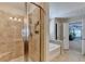 Luxurious bathroom features a glass enclosed shower, soaking tub, and access to the main bedroom at 4395 Wildbrooke Pkwy, Cumming, GA 30041