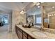 Well-lit bathroom boasts granite counters, dual sinks, tile floors, and separate shower at 4395 Wildbrooke Pkwy, Cumming, GA 30041