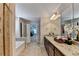 Bright bathroom features granite counters, dual sinks, tile floors, soaking tub, and separate shower at 4395 Wildbrooke Pkwy, Cumming, GA 30041