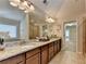 Updated bathroom features granite counters, & sinks, tile floors, and decorative light fixtures at 4395 Wildbrooke Pkwy, Cumming, GA 30041