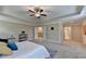 Inviting bedroom features a ceiling fan, carpet floors, walk-in closet, and access to the en suite at 4395 Wildbrooke Pkwy, Cumming, GA 30041
