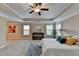 Spacious bedroom features a tray ceiling, ceiling fan, carpet floors, and plenty of natural light at 4395 Wildbrooke Pkwy, Cumming, GA 30041