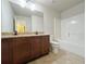 Bathroom featuring double sinks with granite countertop, a bathtub and tile flooring at 1264 Brynhill Ct, Buford, GA 30518