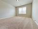 Spacious, carpeted bedroom with neutral walls and a large window for natural light at 1264 Brynhill Ct, Buford, GA 30518