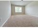 A bright bedroom has neutral walls, carpeting, a window, and white trim at 1264 Brynhill Ct, Buford, GA 30518