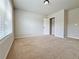 Bedroom with a large window providing ample light, carpet flooring, and a closet at 1264 Brynhill Ct, Buford, GA 30518