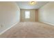 Bedroom with plush carpeting, neutral walls, and natural light from window at 1264 Brynhill Ct, Buford, GA 30518