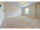 Bedroom with plush carpeting, neutral walls, and natural light from window at 1264 Brynhill Ct, Buford, GA 30518