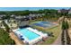 Community pool and tennis courts with lounge chairs and umbrellas at 1264 Brynhill Ct, Buford, GA 30518