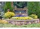 Community entrance sign with stone base and colorful flower bed at 1264 Brynhill Ct, Buford, GA 30518