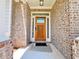Inviting front entrance with brick facade, sidelights, and beautiful wooden door at 1264 Brynhill Ct, Buford, GA 30518