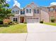 Charming two-story home with manicured lawn, brick accents, and a spacious two-car garage at 1264 Brynhill Ct, Buford, GA 30518